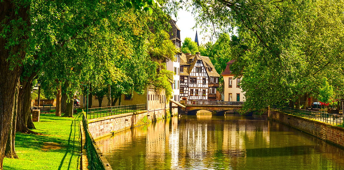 A view down a tree lined canal in Strasbourg, France